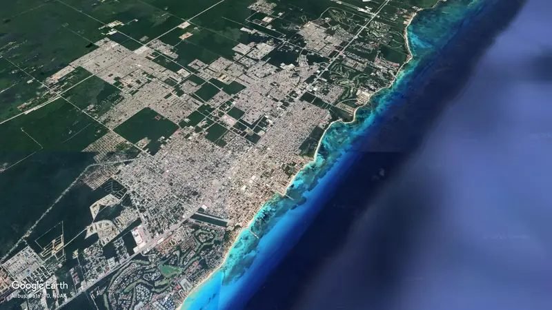 Aerial view of Playa del Carmen from high above, the reef meeting the coast